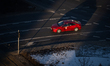 A red Toyota Corolla taxi drives through Rondo Dmowskiego in central Warsaw in winter morn...