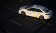 A white Toyota Corolla operated by iTaxi drives through Rondo Dmowskiego in central Warsaw...