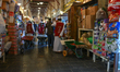 DOHA, QATAR - FEBRUARY 18:  Porters in red vests push wheelbarrows filled with goods thro...