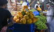 DOHA, QATAR - FEBRUARY 18:  A vendor in a traditional white thobe stands amidst mounds of...
