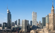 A very wide stitched panorama shows the full winter morning skyline visible from a high fl...