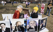 Demonstrators display effigies and placards depicting political and business figures, incl...