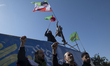 Pro-Government protesters shout anti-U.S. and anti-Israeli slogans during a rally in Tehra...
