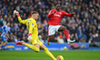 Dilane Bakwa of Nottingham Forest charges down Bart Verbruggen of Brighton during the Prem...