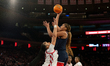 Sarah Strong #21 of the UConn Huskies shoots over the defense of Daniela Abies #16 of the...