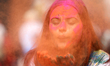A reveler is smeared in colors during the mass Holi celebration at Basantapur Durbar Squar...