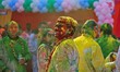 Tourists are smeared in 'gulal' colors during an event organized by Rajasthan Tourism for...