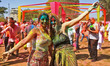 Tourists are smeared in 'gulal' colors during an event organized by Rajasthan Tourism for...