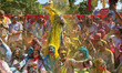 Tourists are smeared in 'gulal' colors during an event organized by Rajasthan Tourism for...
