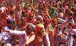 Tourists are smeared in 'gulal' colors during an event organized by Rajasthan Tourism for...