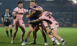 Will Tate is tackled by Hull defenders during the BetFred Super League match between Wakef...