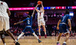 Gavin Griffiths of the Temple Owls attempts a three-point field goal over Jalen Smith of t...