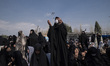 Veiled Iranian worshippers pray while participating in Tehran's Friday prayers at Imam Kho...