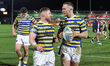 Luke Yates of Warrington Wolves and Ben Currie of Warrington Wolves celebrate the win duri...