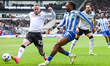 Joe Ward of Derby County intercepts the attacking ball by Tayo Adaramola of Sheffield Wedn...