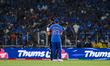 New Zealand's Daryl Mitchell talks to India's captain Suryakumar Yadav during the final ma...