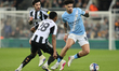 Nico O'Reilly of Manchester City turns from Joe Willock and Sandro Tonali of Newcastle Uni...