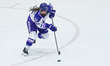 Natalie Buchbinder #22 of Minnesota Frost skates on the ice as she drives the puck forward...