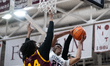 Jasiah Jarvis attempts a difficult layup through contact during the Catholic High School A...