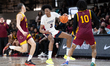 Adonis Ratliff looks for an option while being double-teamed during the Catholic High Scho...
