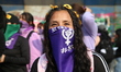 A woman participates in a rally for the International Women's Day commemoration, demanding...