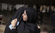 Two Iranian women mourn during a funeral for a man who is killed during the U.S.-Israeli m...