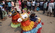Devotees perform a traditional dance before carrying idols of Hindu gods and goddesses thr...