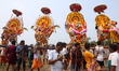 Devotees carry idols of gods and goddesses through the waters of Chilika Lake during the 1...
