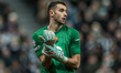 Barcelona goalkeeper Joan Garcia adjusts his gloves during the UEFA Champions League Last...