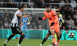 Marc Bernal of Barcelona makes a pass under pressure from Jacob Ramsey of Newcastle United...