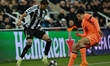 William Osula of Newcastle United takes on Joao Cancelo of Barcelona during the UEFA Champ...