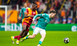 Wilfried Stephane Singo of Galatasaray A.S. is in action with Florian Wirtz of Liverpool F...