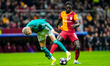 Hugo Ekitike of Liverpool FC is challenged by Davinson Sanchez of Galatasaray A.S. during...