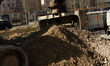Excavators repair a sidewalk on the street in Warsaw, Poland, on March 3, 2026. 