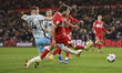 Aidan Morris of Middlesbrough shoots on goal under pressure from Sonny Carey of Charlton A...