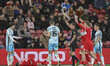 Referee Adam Herczeg shows the yellow card to Luke Chambers of Charlton Athletic during th...