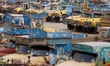 Trucks remain parked at a stand as a man walks past amid concerns over instability in the...