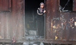 A Palestinian girl stands near the site of an Israeli strike on a tent camp sheltering dis...