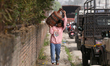 A Nepali consumer carries empty LPG cylinders as they rush to gas depots to refill them as...