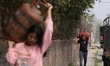 A Nepali consumer carries empty LPG cylinders as they rush to gas depots to refill them as...