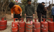 Nepali consumers wait in line carrying empty LPG cylinders as they rush to gas depots to r...