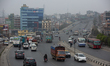 Vehicles ply on the roads of Kathmandu, Nepal, on March 12, 2026, as a polluted haze cover...