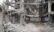 An Iranian firefighter works on the ruins of a building that is destroyed during the U.S.-...