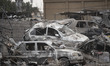 Vehicles are located on the ruins of a building destroyed during the U.S.-Israeli military...