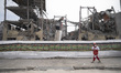 An Iranian firefighter walks past the ruins of buildings that are destroyed during the U.S...