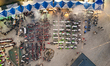 An aerial view captures hundreds of Muslims gathered at long tables for a communal Iftar m...