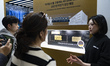 Visitors look at the Samsung SDI ''SolidStack'' booth featuring all-solid-state battery te...
