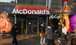 SHANGHAI, CHINA - MARCH 8: 
 People walk past a McDonald's restaurant featuring large adv...