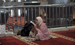 Muslims read the Quran while in Itikaf at the Istiqlal Mosque in Jakarta, Indonesia, on Ma...