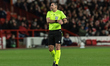 Referee Rade Obrenovic officiates during the UEFA Europa League Last 16 match between Nott...